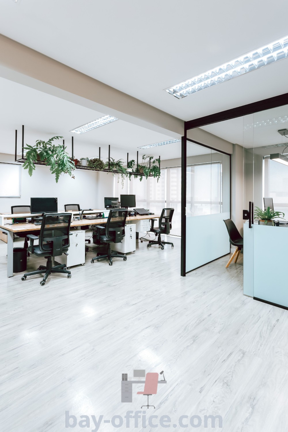 Architectural office interior showcasing modern desks, plants on the wall, and glass doors that create a spacious and inviting working environment. Perfect for inspiring productivity and implementing decorating ideas for small spaces. Explore more at bay-office.com.