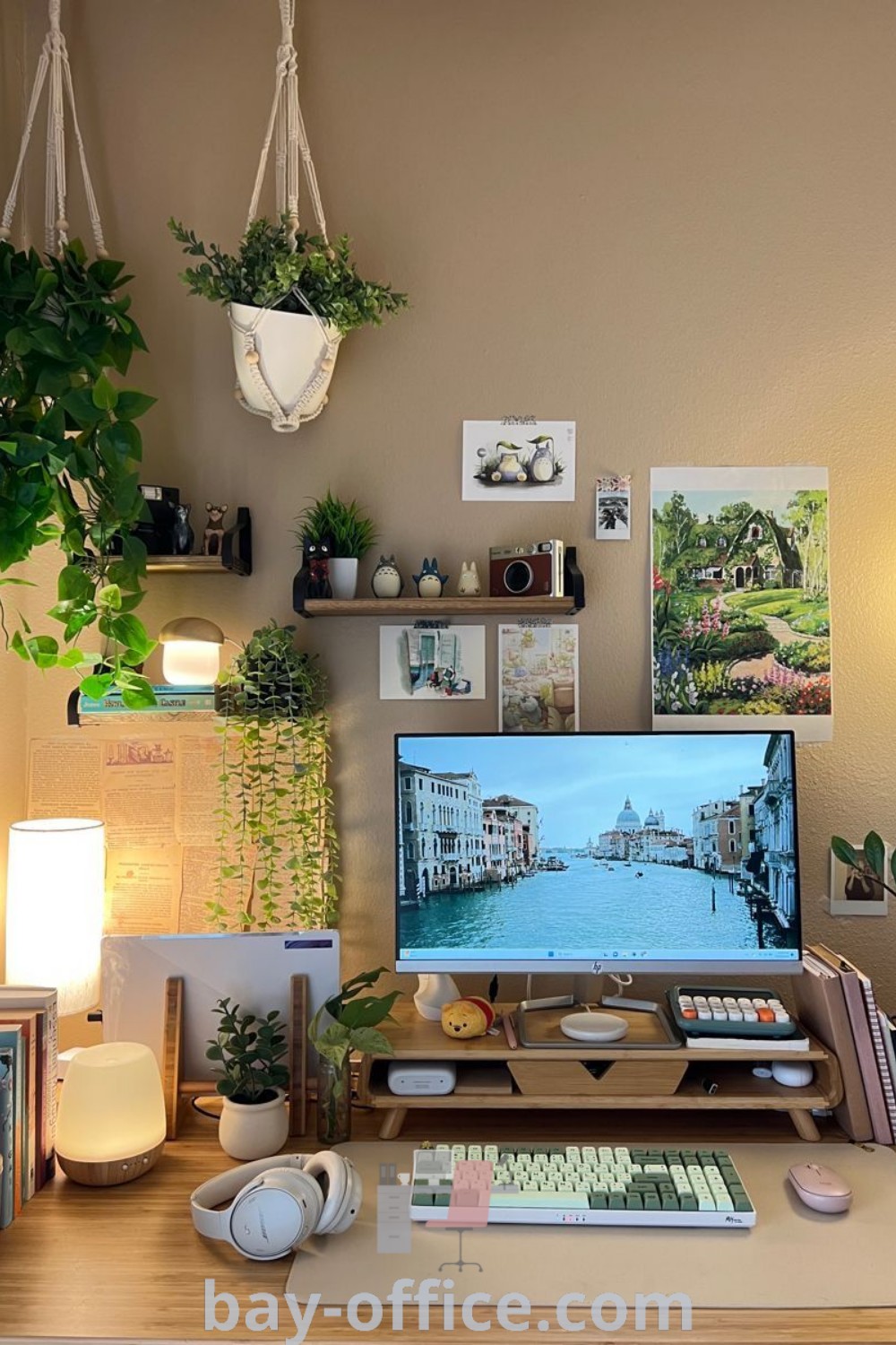 Cozy work desk setup with a computer monitor, keyboard, and headphones surrounded by plants, showcasing natural decor ideas for small spaces. Perfect for enhancing productivity and creating a warm work-from-home environment. Discover more decor ideas at bay-office.com.