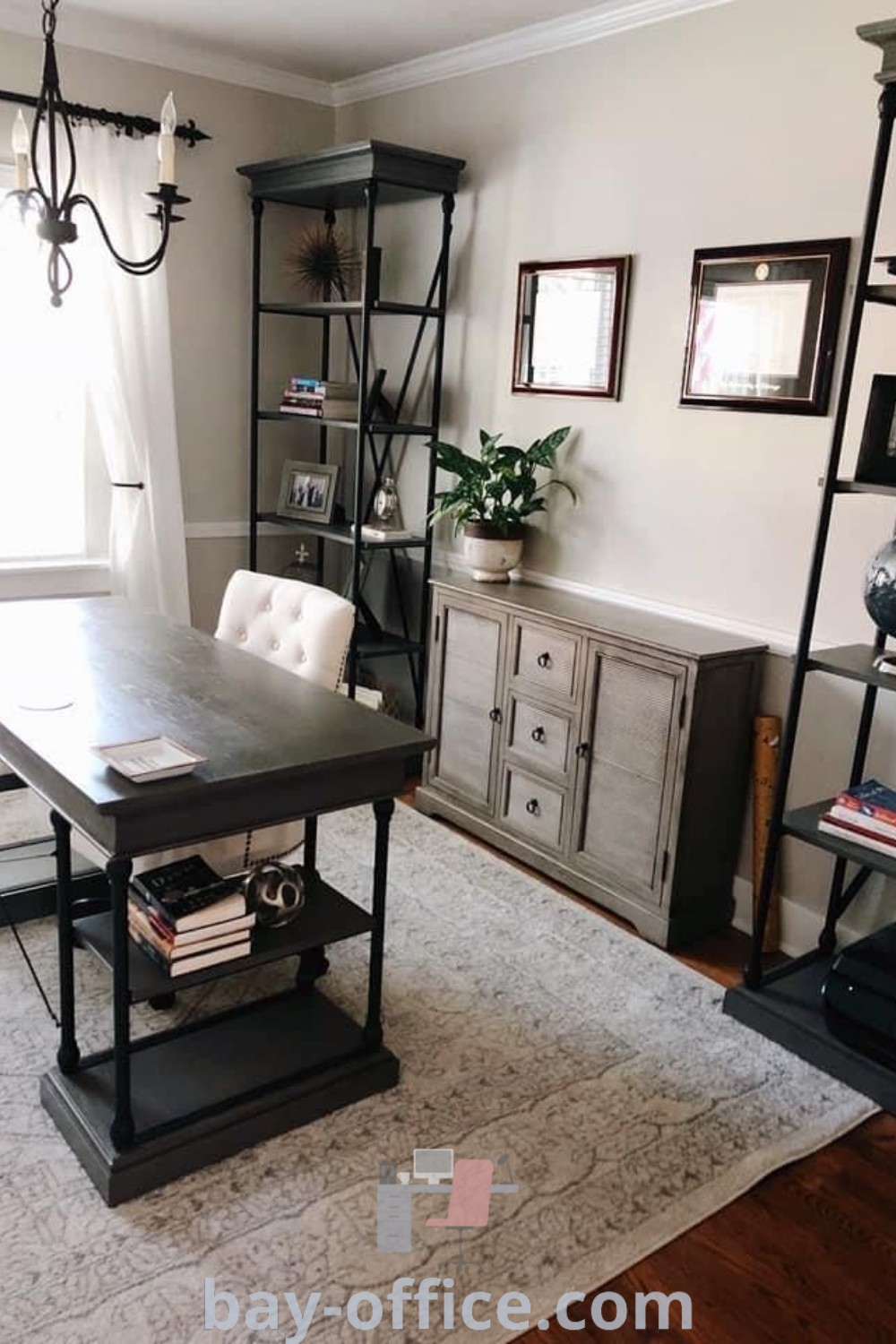 Home office with dark wood furniture including a black desk, cozy chairs, and shelves, embodying design tips for small spaces and inspiring ideas you