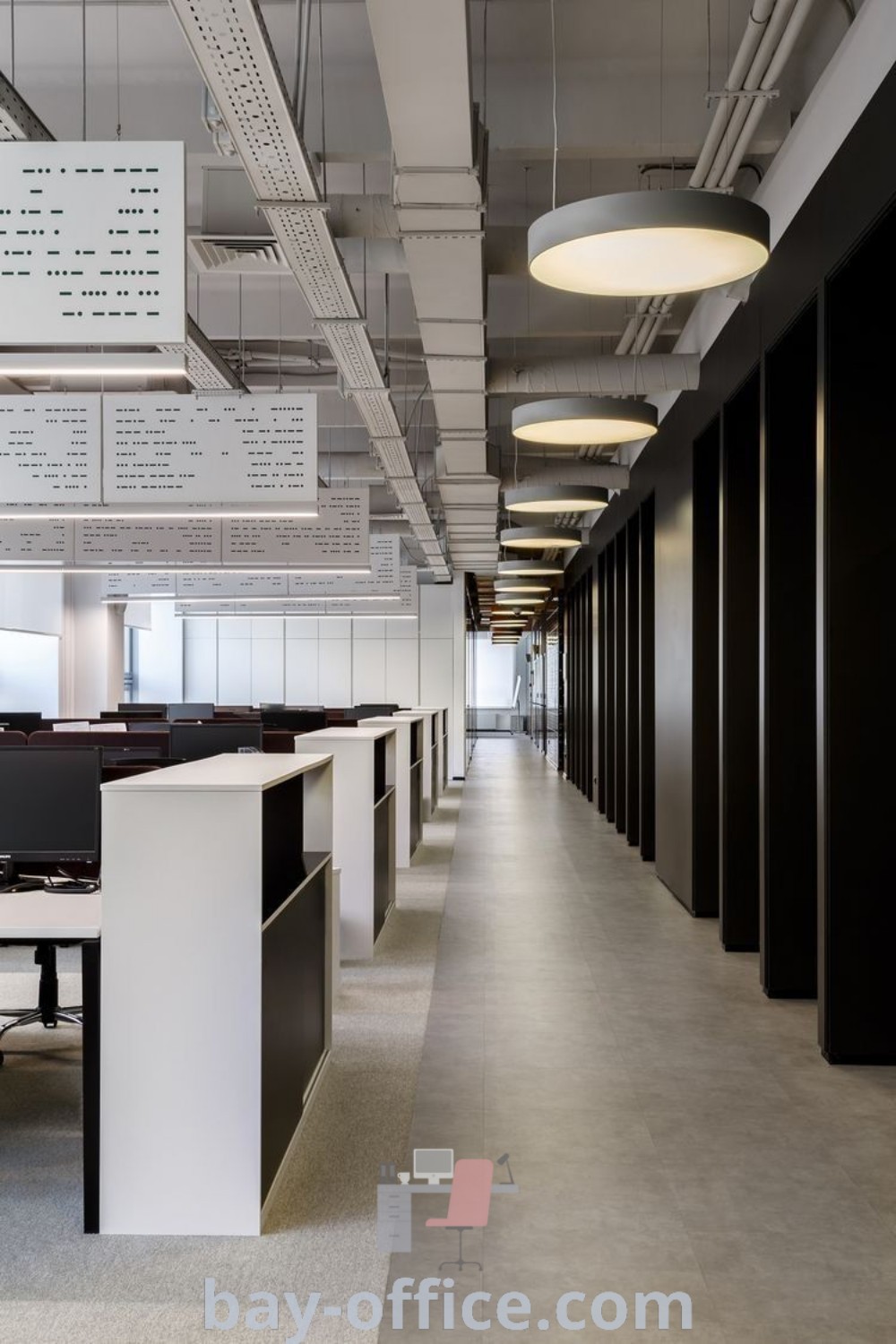 Empty office space with desks, black filing cabinets, and hanging signs, showcasing contemporary and industrial office design elements. Perfect for enhancing productivity with modern office interiors. Explore inspiring ideas for optimizing workspace decor trends at bay-office.com.