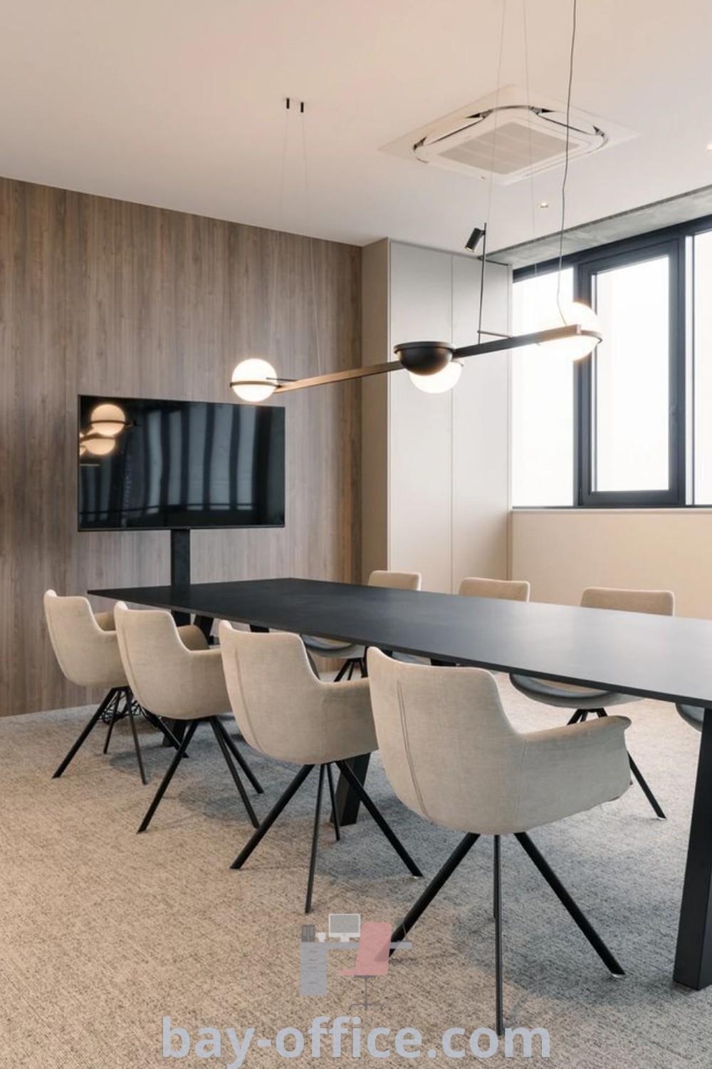 Empty conference room with chairs and flat-screen TV showcasing inviting meeting room interior design. Discover cozy and functional decorating ideas for office spaces to inspire productivity at bay-office.com.