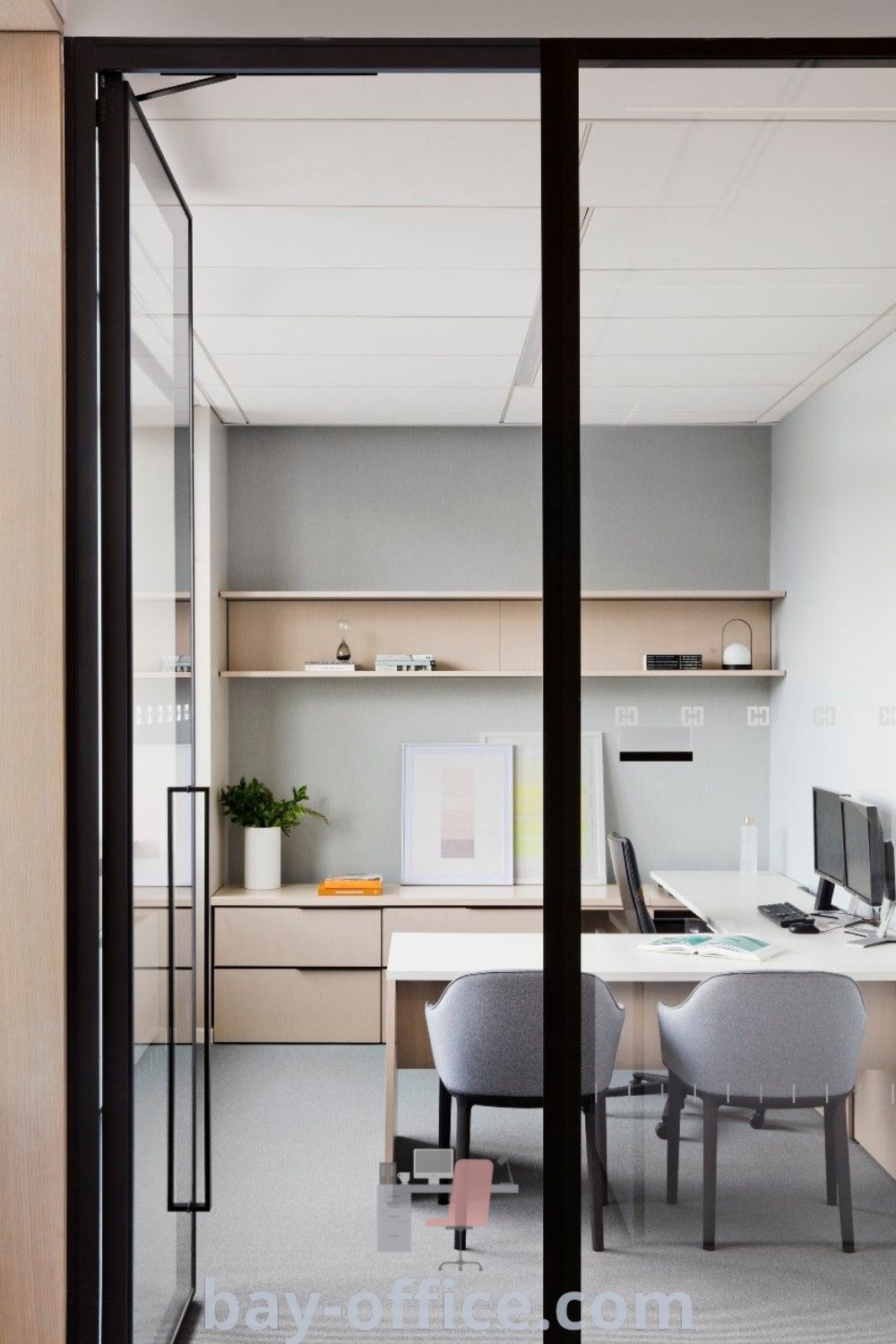 Small private office with modern desks and chairs in front of a glass door, showcasing design tips for small spaces, cozy aesthetics, and functional decor ideas that inspire productivity. Explore more inspiring office designs at bay-office.com.