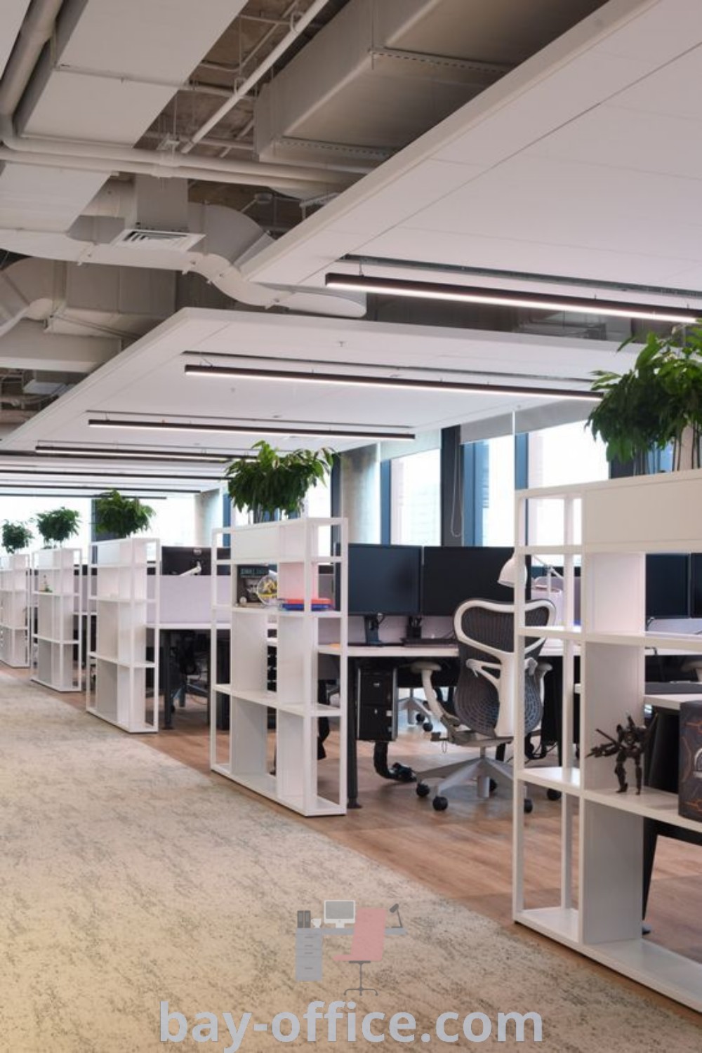 Contemporary office design featuring an open layout with multiple desks and vibrant plants for an inspiring and productive workspace. Discover best practices in office design concepts and ideas that enhance your work environment at bay-office.com.