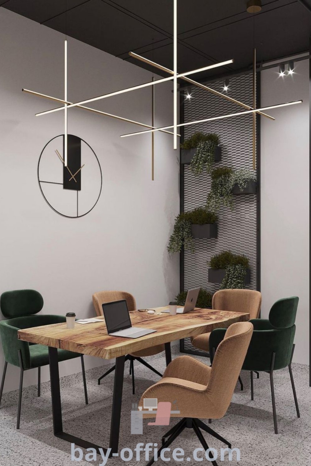 Wooden table surrounded by green chairs in a small meeting room, featuring a clock on the wall. This modern office design combines minimalism and industrial elements, providing inspiring decor ideas for small spaces. Discover more best design tips at bay-office.com.