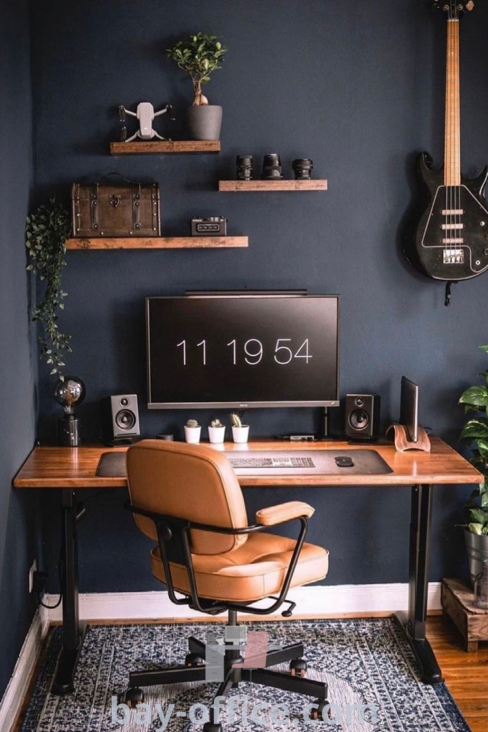 Home office with chic desk setup, guitar on the wall, and cozy chair, offering design tips and inspiring decor ideas for small spaces. Find more inspiration at bay-office.com.