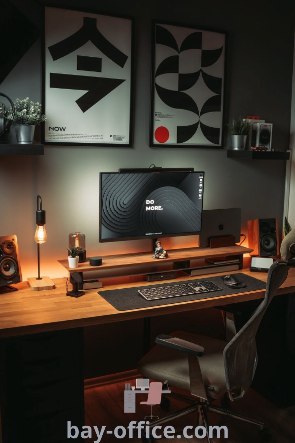 A stylish black and wood desk setup featuring a computer, speakers, and framed art pieces, combining modern decor ideas for small spaces. Enhance your home office atmosphere and productivity with thoughtful design tips and decor ideas for a cozy working environment at bay-office.com.